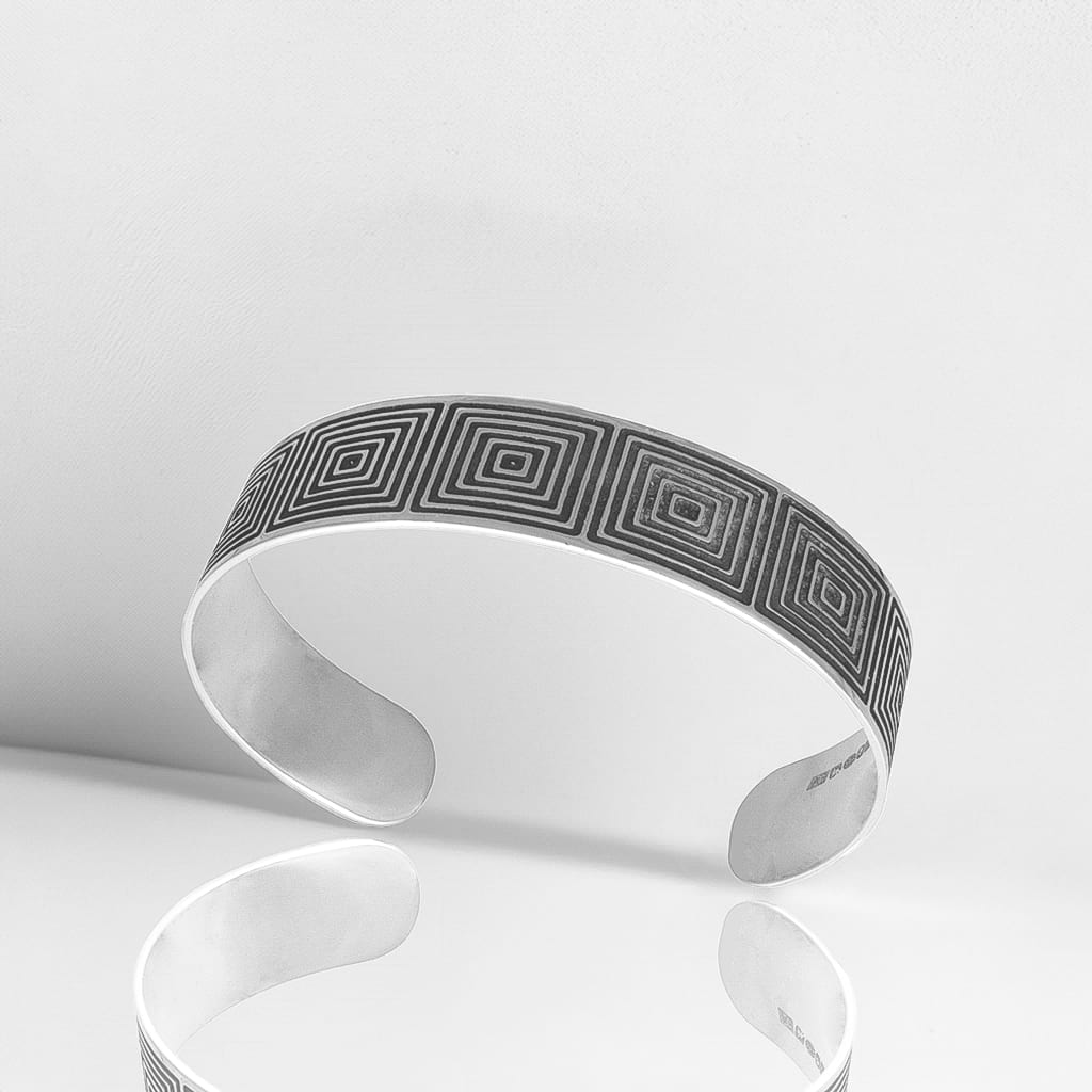 narrow optical cuff with oxidised design on a white background