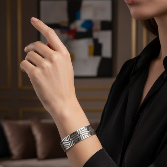 Person wearing a silver bracelet in an indoor setting