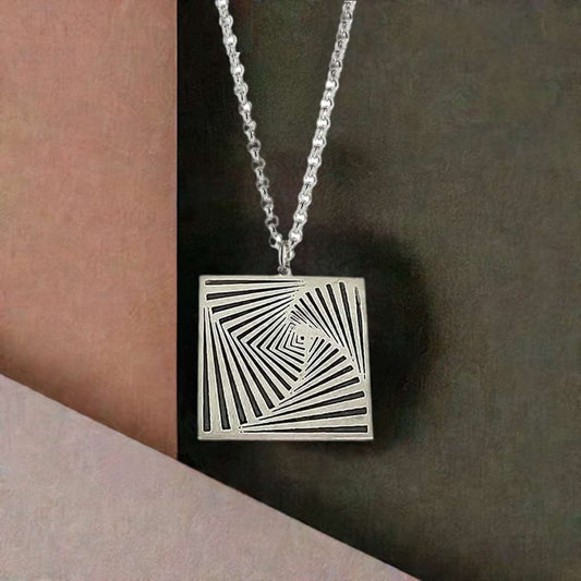 Silver square pendant in front of pastel coloured background