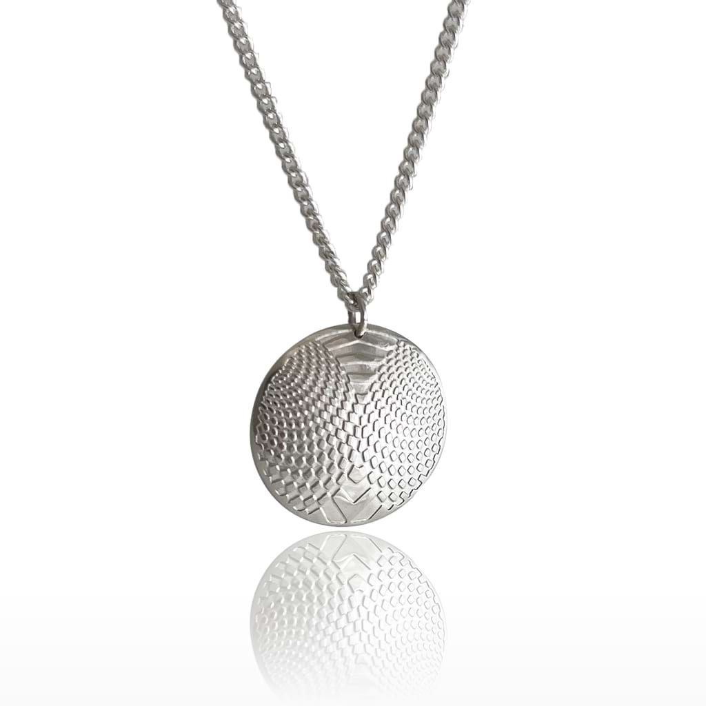 siler domed pendant with optical design on a white background hanging