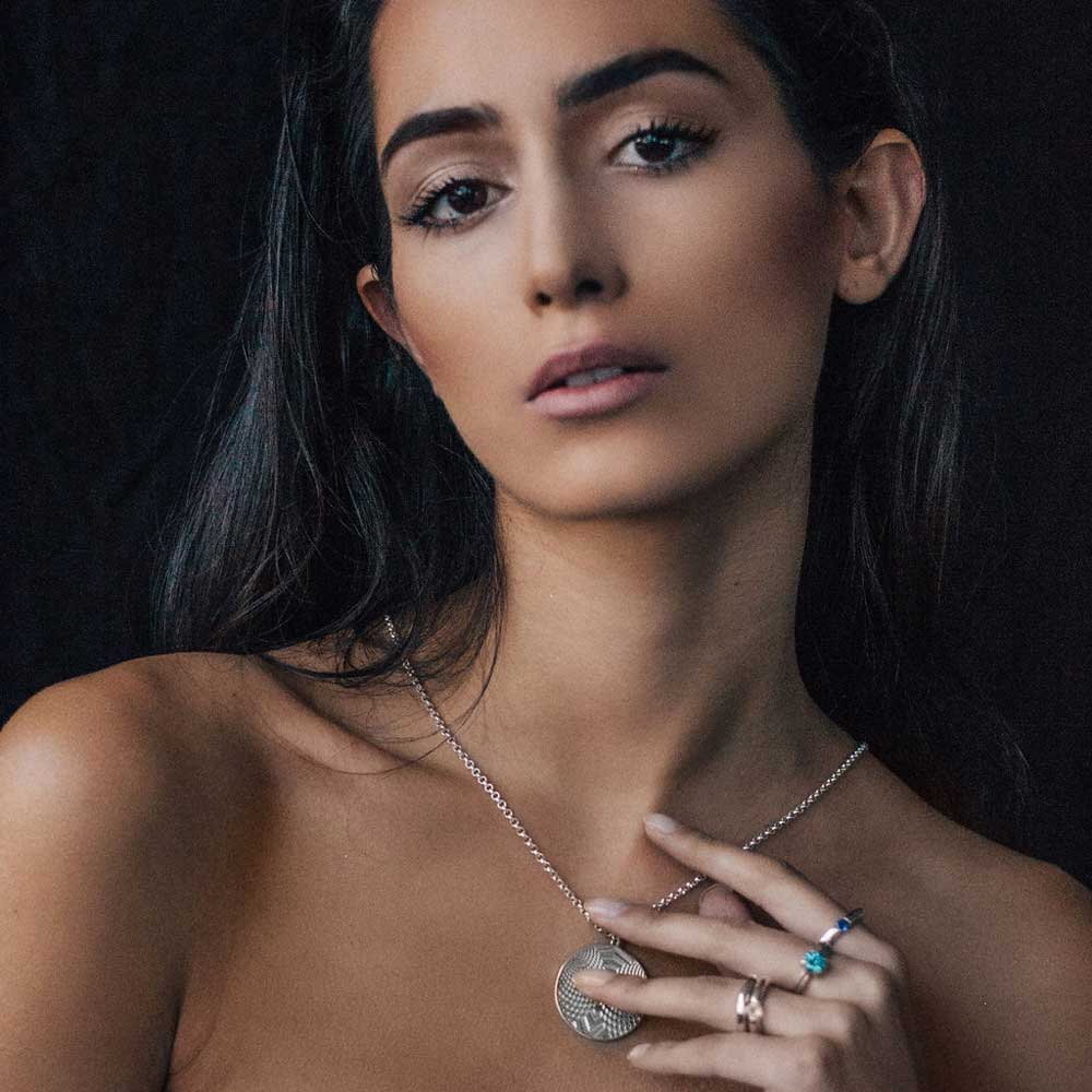 Women-holding=Optical-Pendant-Necklace