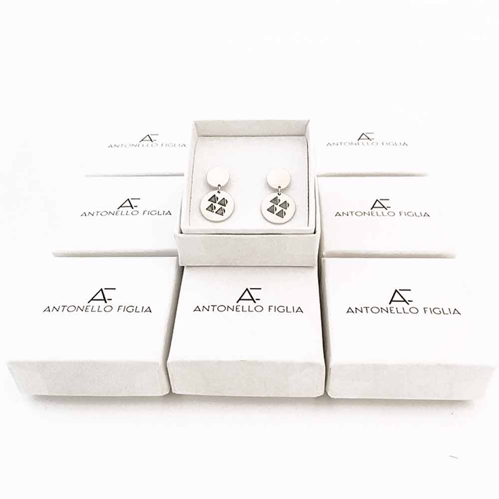 TRIANGLE EARRINGS over cardboard boxes