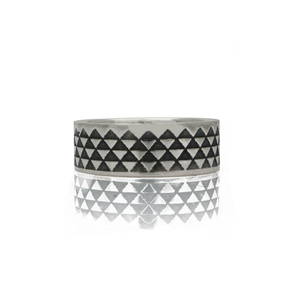 triangle ring with oxidised design detail on a white background