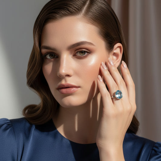 Silver ring with faceted Topaz gemstone on a white abckground