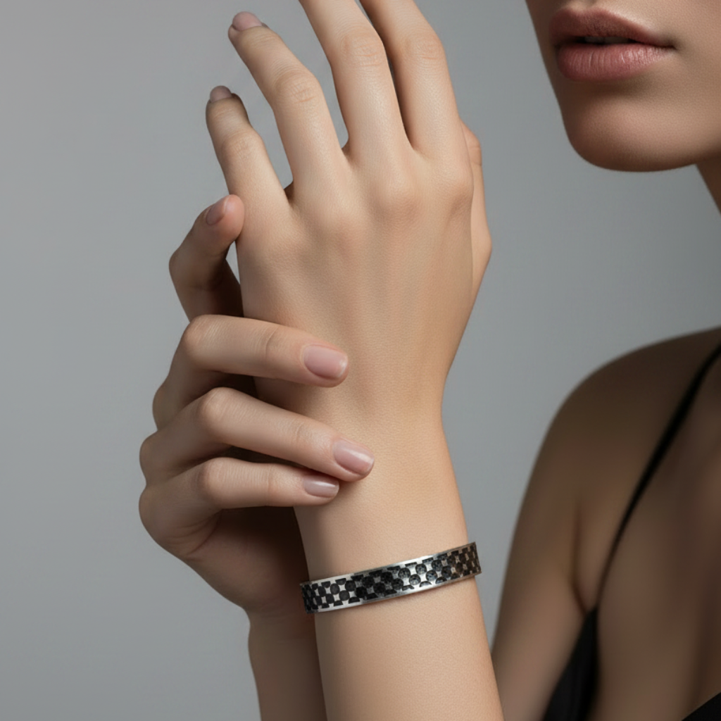 Woman wearing a black and white polka dot bracelet on a gray background