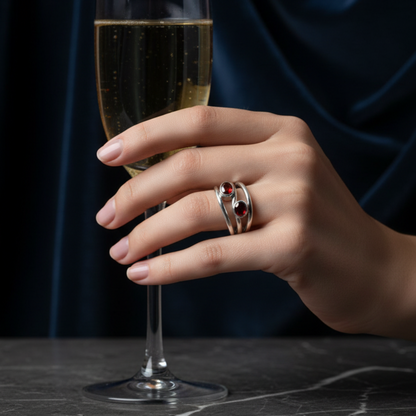Hand holding a glass of champagne with a dark background