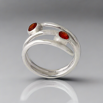 Silver ring with two red gemstones