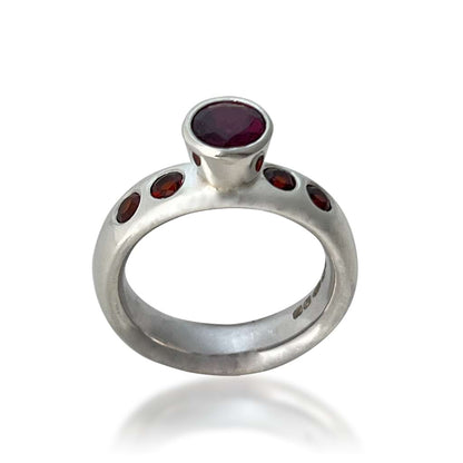 Silver garnet ring on a white background