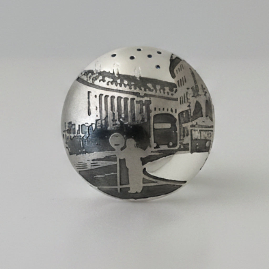 Silver round brooch on a white background