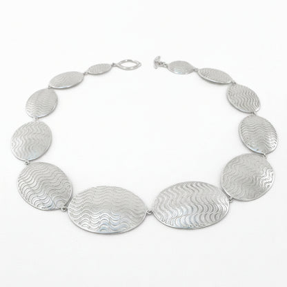 Silver necklace with oval pendants on a white background
