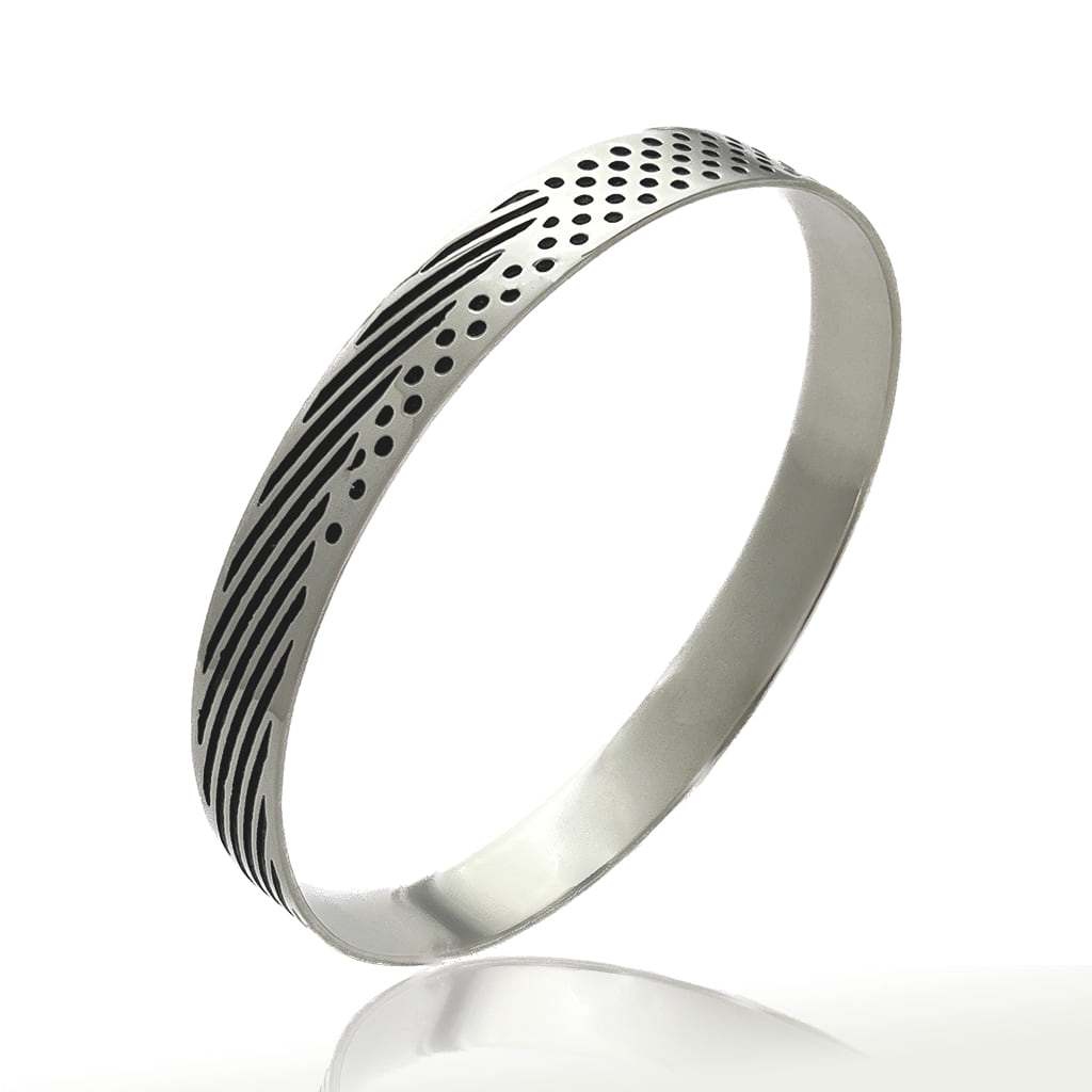 Silver bangle partly oxidised with circles and lines