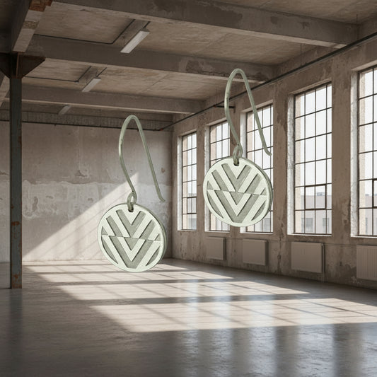 pair of silver earing floating in a warehouse