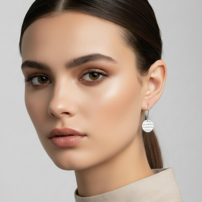 Woman wearing earrings with a neutral background