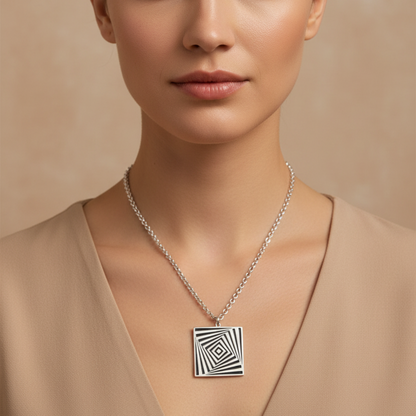 Woman wearing a necklace with a geometric pendant against a beige background