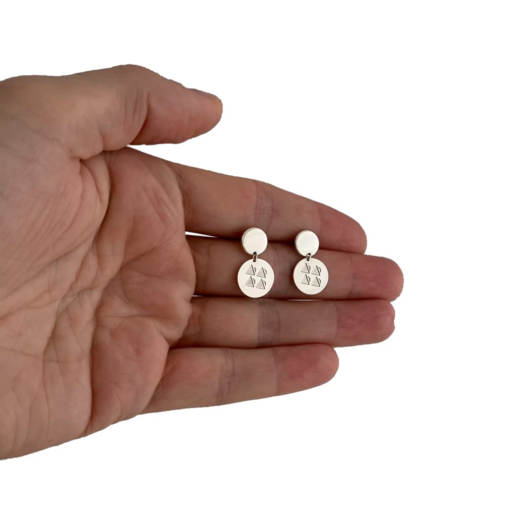 discs earrings on the palm of a hand