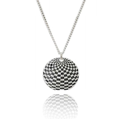 Silver domed pendant with oxidised design based on optical illusion