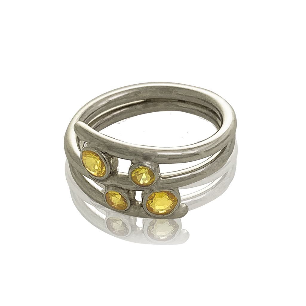 contemporary silver ring with yellow sapphires on a white background